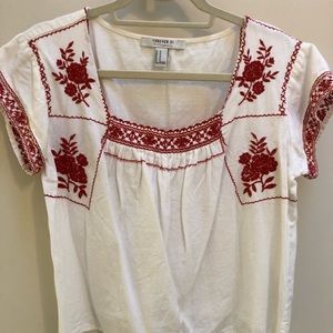 White shirt with red embroidery detailing